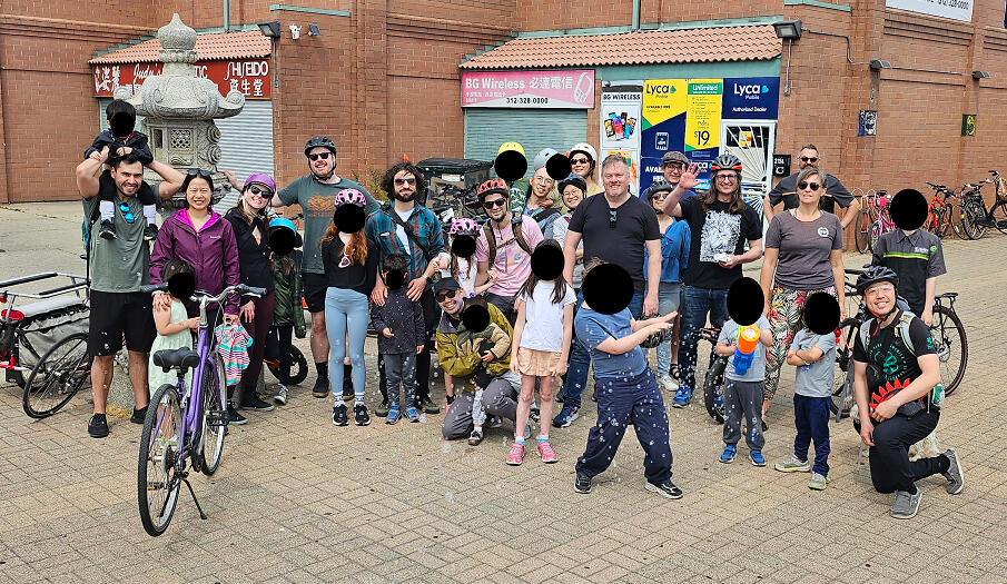 A group of three dozen children and adults in Chicago's Chinatown with bikes and helmets.