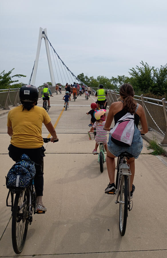 A group of children and adults going over the 35th St pedestrian bridge.